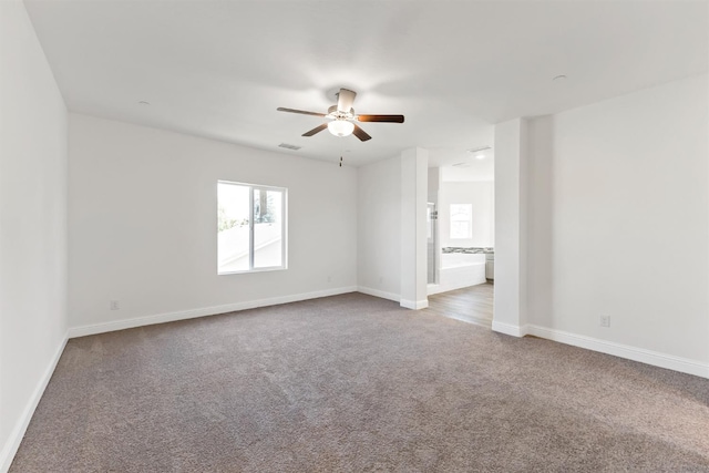 carpeted empty room with ceiling fan