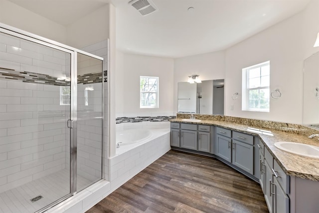 bathroom with wood-type flooring, vanity, and separate shower and tub