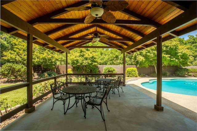 view of patio with ceiling fan and a fenced in pool