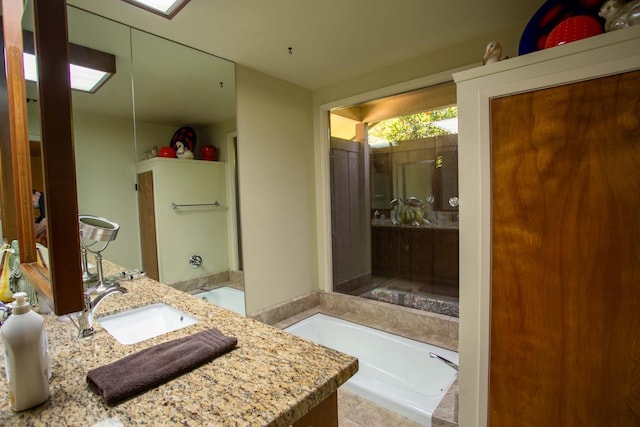 bathroom with vanity and a washtub