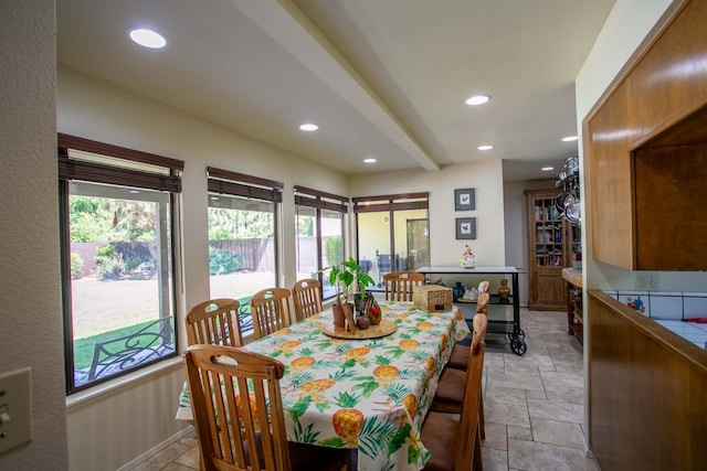 dining space with beamed ceiling