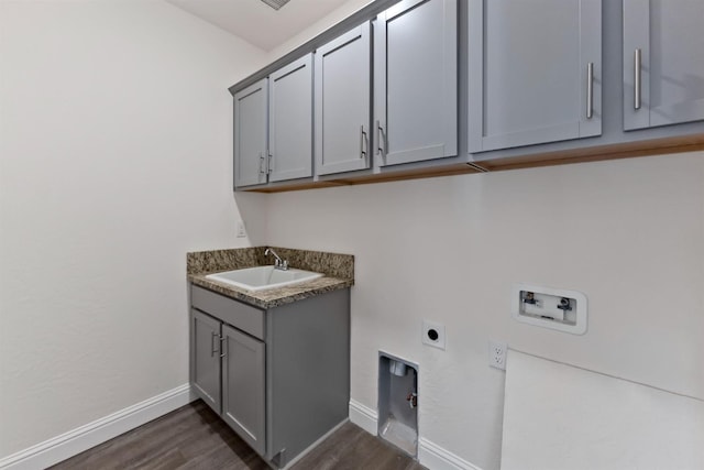 laundry area with sink, dark wood-type flooring, cabinets, washer hookup, and electric dryer hookup