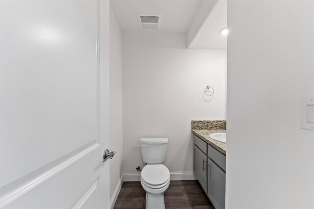 bathroom featuring hardwood / wood-style floors, vanity, and toilet