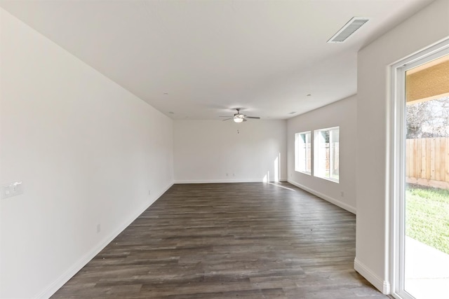 empty room with ceiling fan and dark wood-type flooring