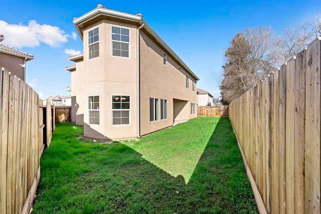 back of house with a lawn