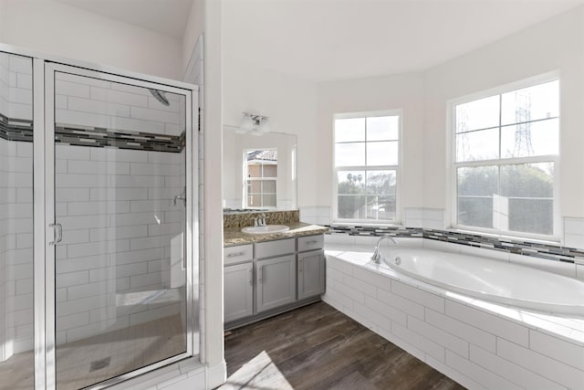 bathroom featuring separate shower and tub, hardwood / wood-style floors, and vanity