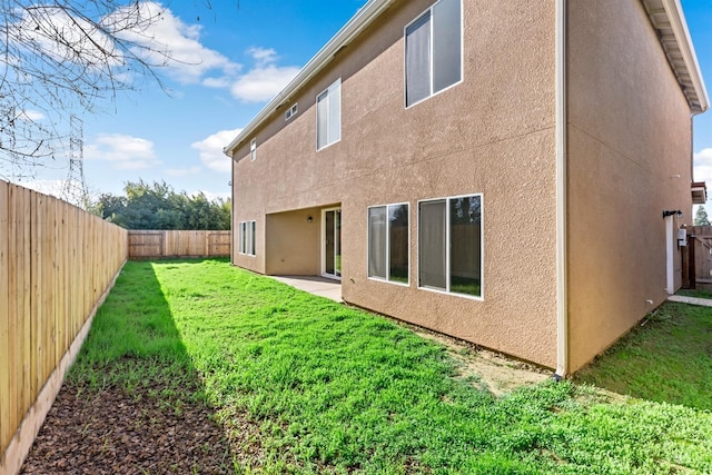 rear view of property featuring a yard