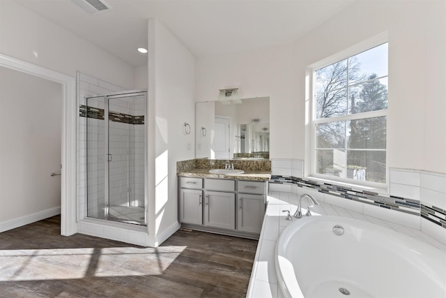 bathroom featuring hardwood / wood-style flooring, vanity, and independent shower and bath