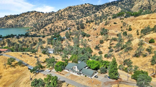 drone / aerial view featuring a water and mountain view