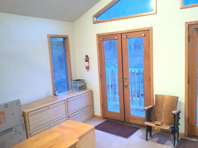 entryway with carpet floors and french doors