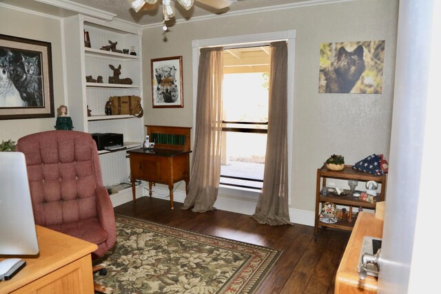 office area with baseboards, crown molding, a ceiling fan, and dark wood-style flooring