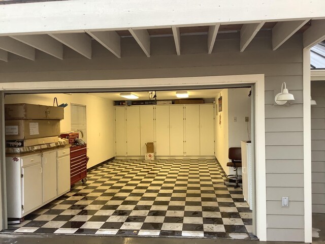 basement with a garage and tile patterned floors