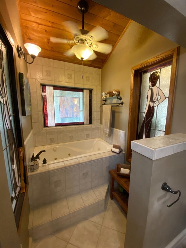 full bath with tile patterned floors, lofted ceiling, a jetted tub, ceiling fan, and wooden ceiling