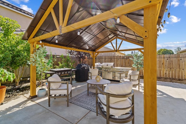 view of patio / terrace with exterior kitchen and a gazebo