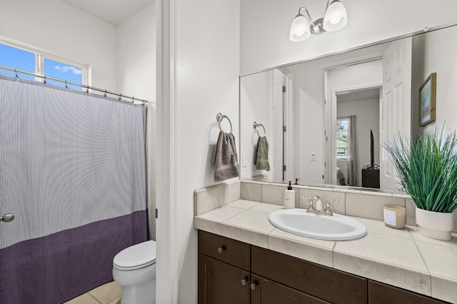 bathroom featuring tile patterned floors, walk in shower, vanity, and toilet