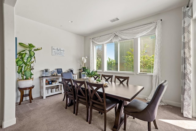 dining space with light colored carpet