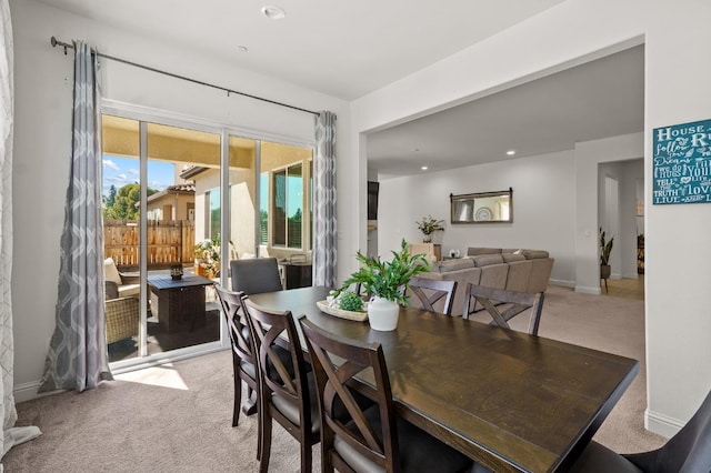 dining space with light carpet