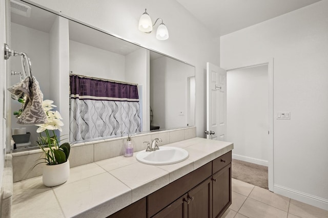 bathroom with tile patterned flooring and vanity