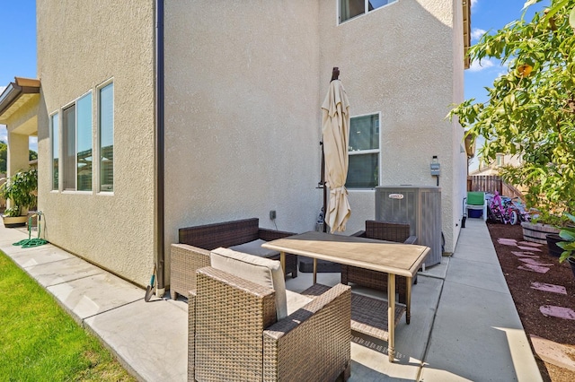 rear view of property featuring central AC and a patio area