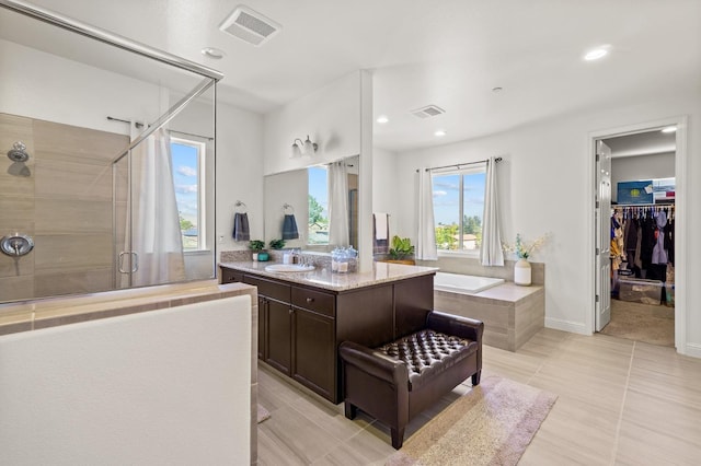 bathroom with vanity, plus walk in shower, and tile patterned floors