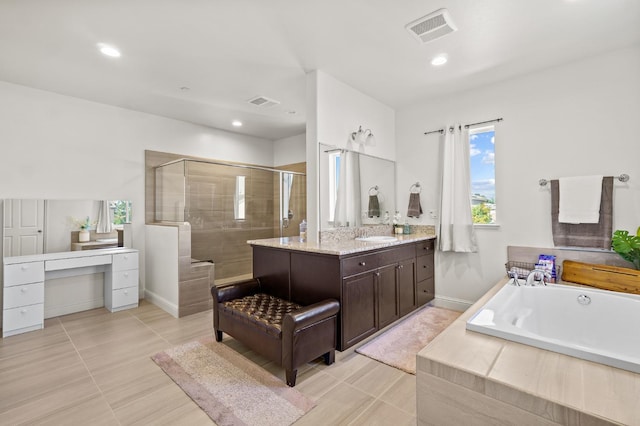 bathroom featuring tile patterned flooring, vanity, and separate shower and tub