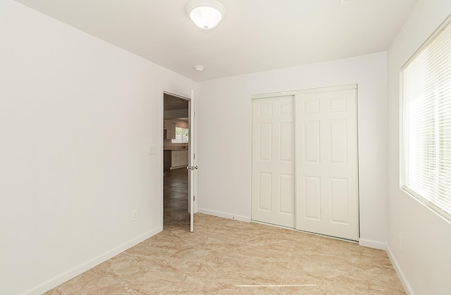 unfurnished bedroom with a closet