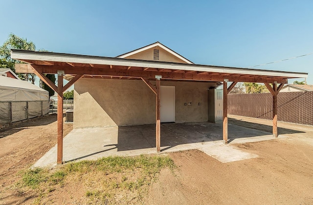 view of parking / parking lot featuring a carport