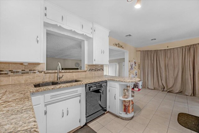 kitchen with white cabinets, sink, black dishwasher, light tile patterned flooring, and kitchen peninsula