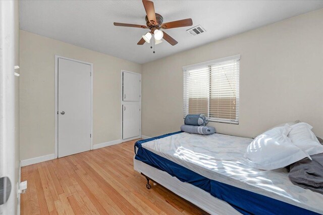 bedroom featuring ceiling fan and light wood-type flooring