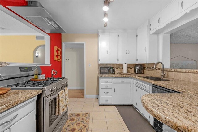 kitchen featuring light tile patterned floors, stainless steel appliances, white cabinetry, and sink