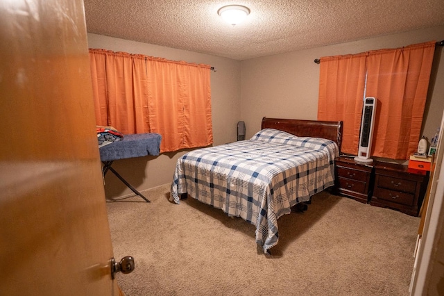 bedroom featuring a textured ceiling and carpet floors