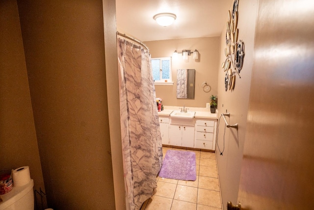 bathroom with vanity, tile patterned flooring, and toilet