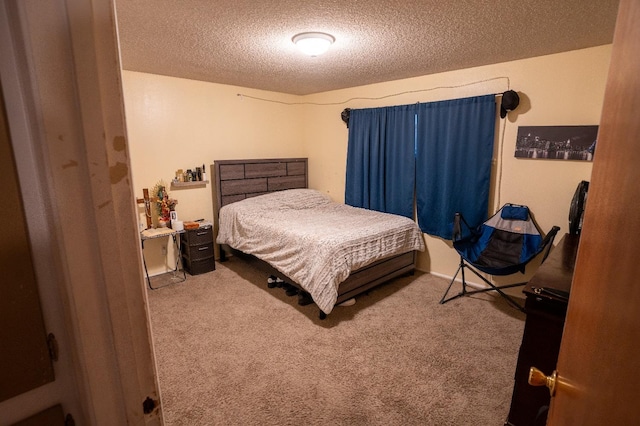 bedroom featuring a textured ceiling and carpet