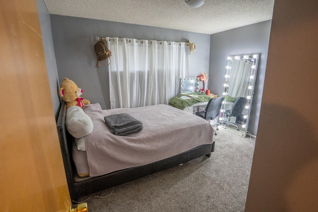 bedroom featuring multiple windows, a textured ceiling, and carpet floors