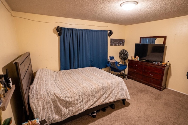 bedroom with a textured ceiling and carpet flooring