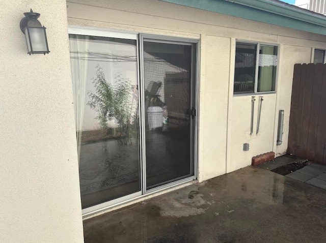 doorway to property with a patio area