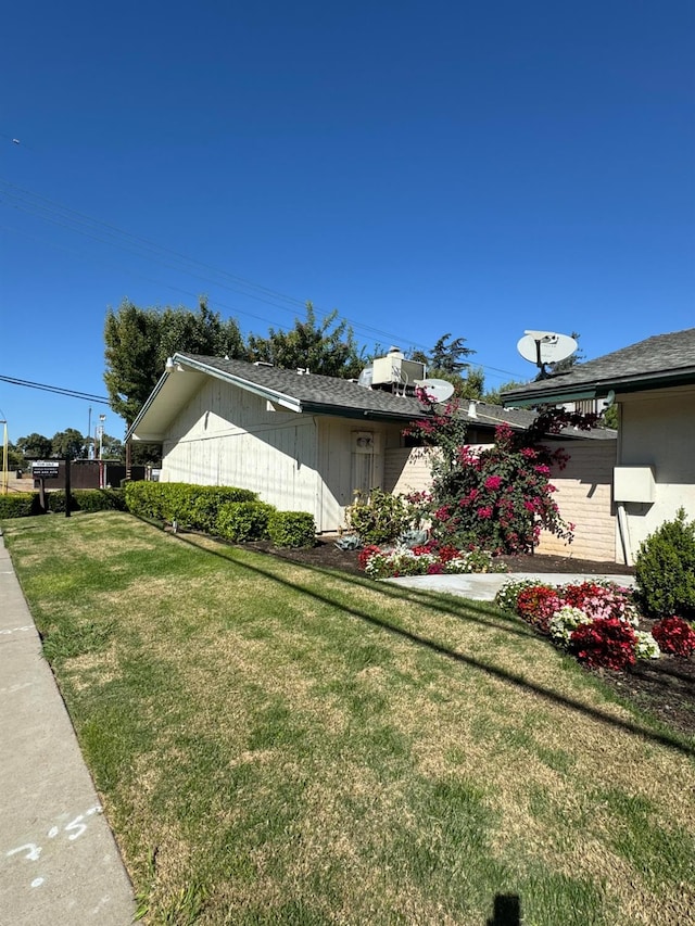 view of side of property with a yard