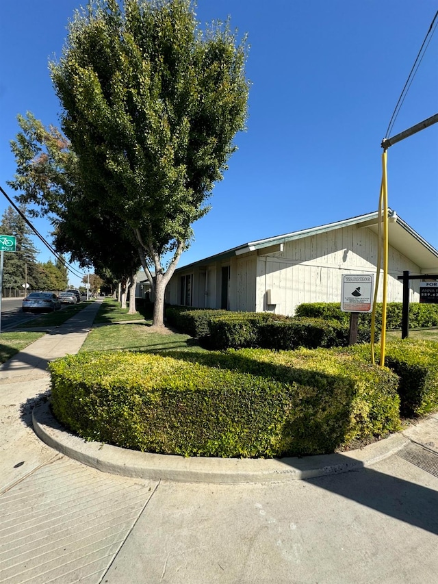 view of side of property with a lawn