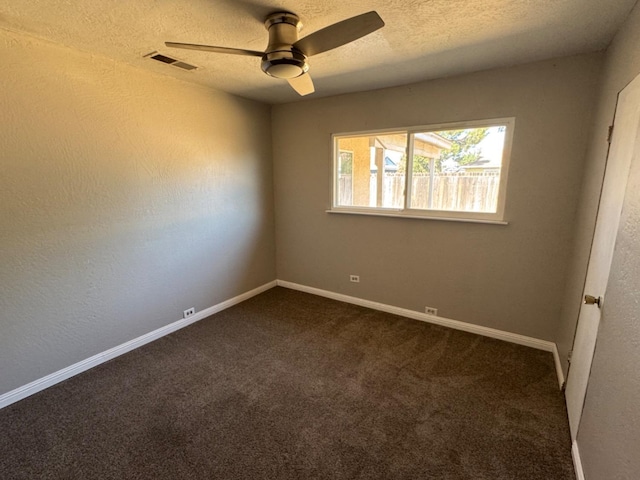 carpeted spare room with ceiling fan and a textured ceiling