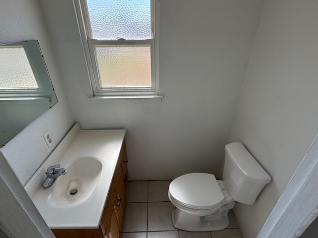 bathroom with vanity, toilet, and tile patterned floors