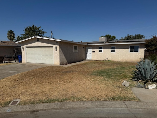 single story home featuring a garage and a front yard