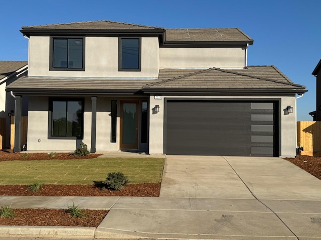 view of front of property featuring a front lawn and a garage