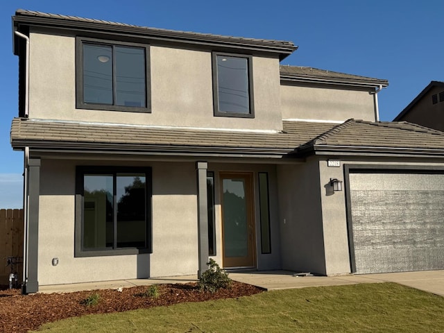 view of front of house featuring a front yard and a garage