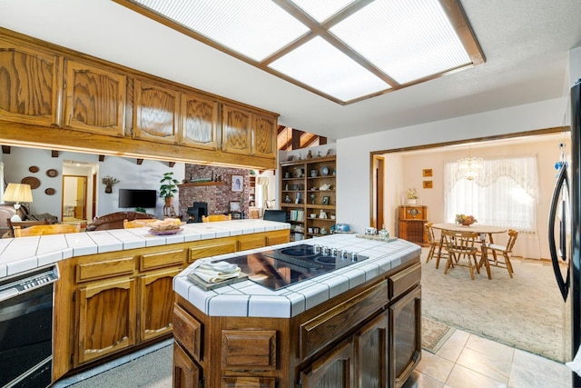 kitchen with light carpet, tile counters, and a center island