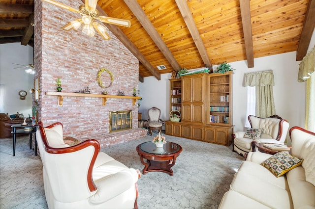 carpeted living room with a fireplace, ceiling fan, and beamed ceiling