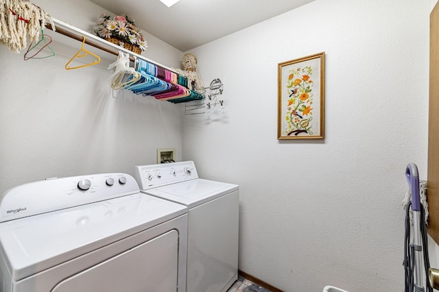 clothes washing area with washer and clothes dryer