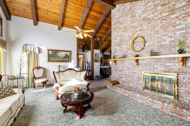 living room with carpet floors, a fireplace, beamed ceiling, wooden ceiling, and ceiling fan