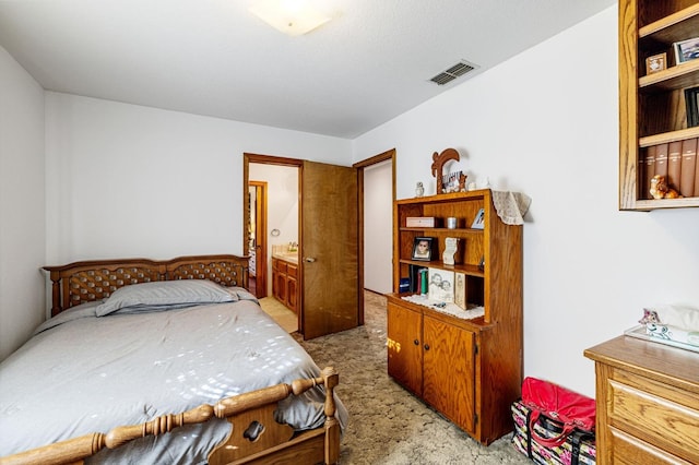 carpeted bedroom featuring ensuite bathroom