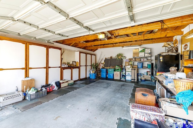 garage with black fridge and a garage door opener