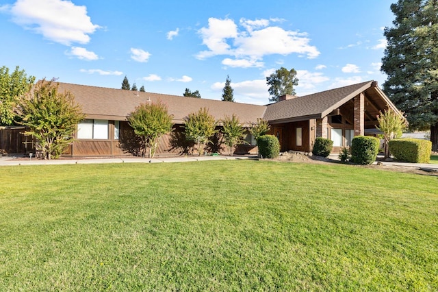 ranch-style home with a front lawn